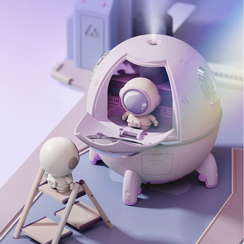 A purple space capsule humidifier with an open front hatch showing a small astronaut toy inside releasing mist.