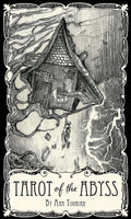 The monochrome front cover of the Tarot of the Abyss deck box by Ana Tourian featuring an illustration of a tilted house.