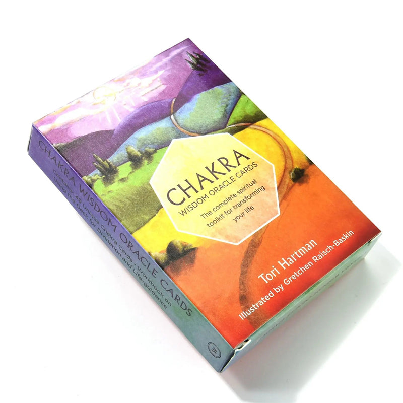 High-angle top view of the Chakra Wisdom Oracle rigid storage box container. The layout highlights the central yellow hexagonal brand emblem and colorful rolling hills watercolor landscape illustrated by Gretchen Raisch-Baskin, complete with clean side text lines.