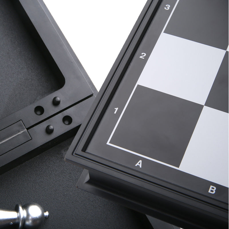 Close-up view of the alphanumeric coordinate markers on the corner of a folding plastic chess board.