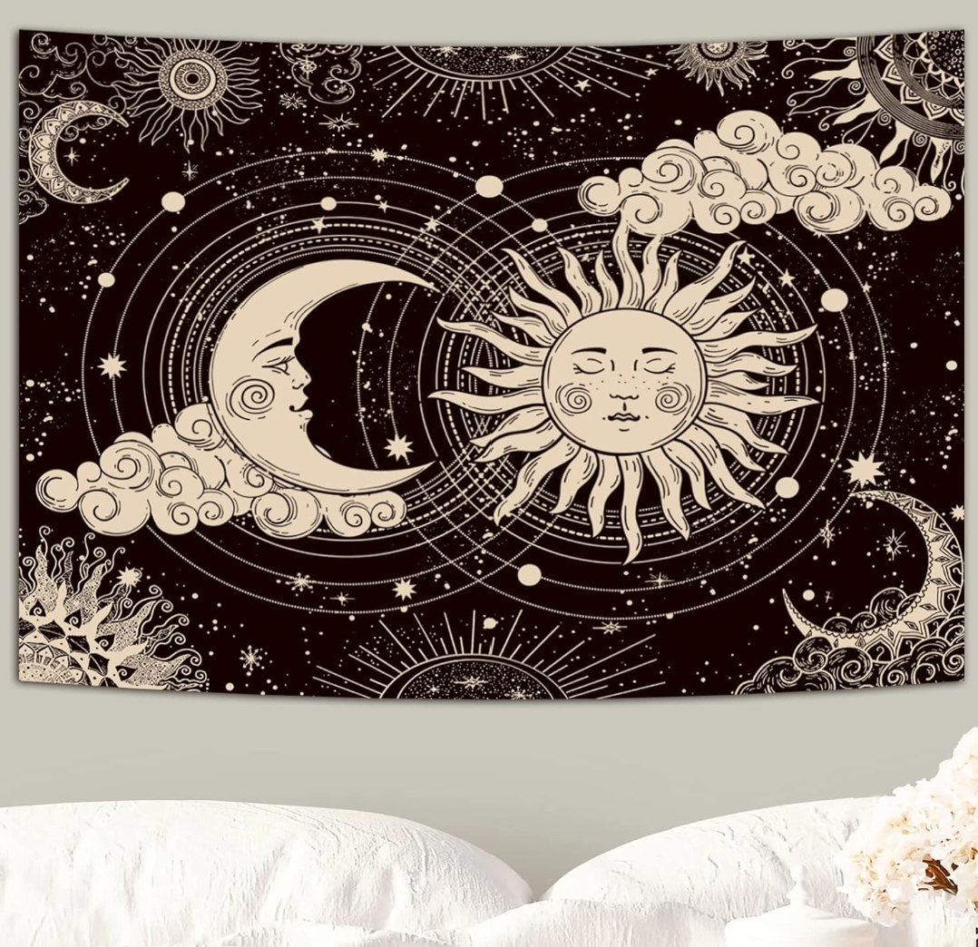 Aesthetic black and white celestial tapestry featuring a mystic sun and a crescent moon with faces, surrounded by stars, clouds, hanging above a bed