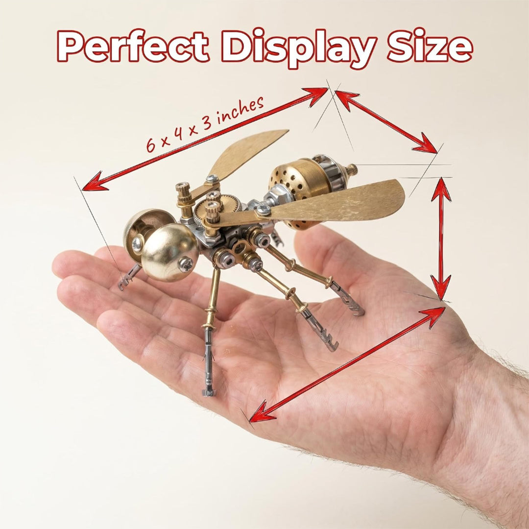 A close-up shot of a human hand holding the miniature brass mechanical fly model to demonstrate scale. Red dimension arrows map out the spatial boundary with handwritten text reading "6 by 4 by 3 inches" underneath the main heading "Perfect Display Size."