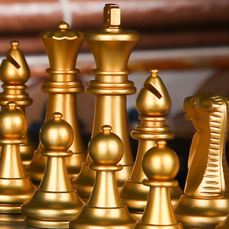 Extreme macro photography of an electroplated gold King piece surrounded by a matching plastic army.