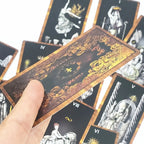 A hand holding a fanned group of cards emphasizing the detailed geometric lines and intricate center backing patterns.