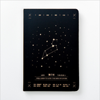 Front view of a matte black hardcover Leo zodiac journal featuring a gold star map constellation design centered on a clean white background.