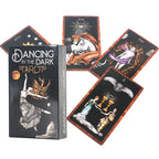 Dancing in the Dark Tarot cards fanned out around a black tuck box showing a woman reaching toward a glowing crescent moon.