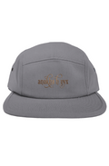 Grey five-panel camper style hat featuring the elegant Anakha H Nyx calligraphy script logo embroidered in a warm copper bronze tone across the front.