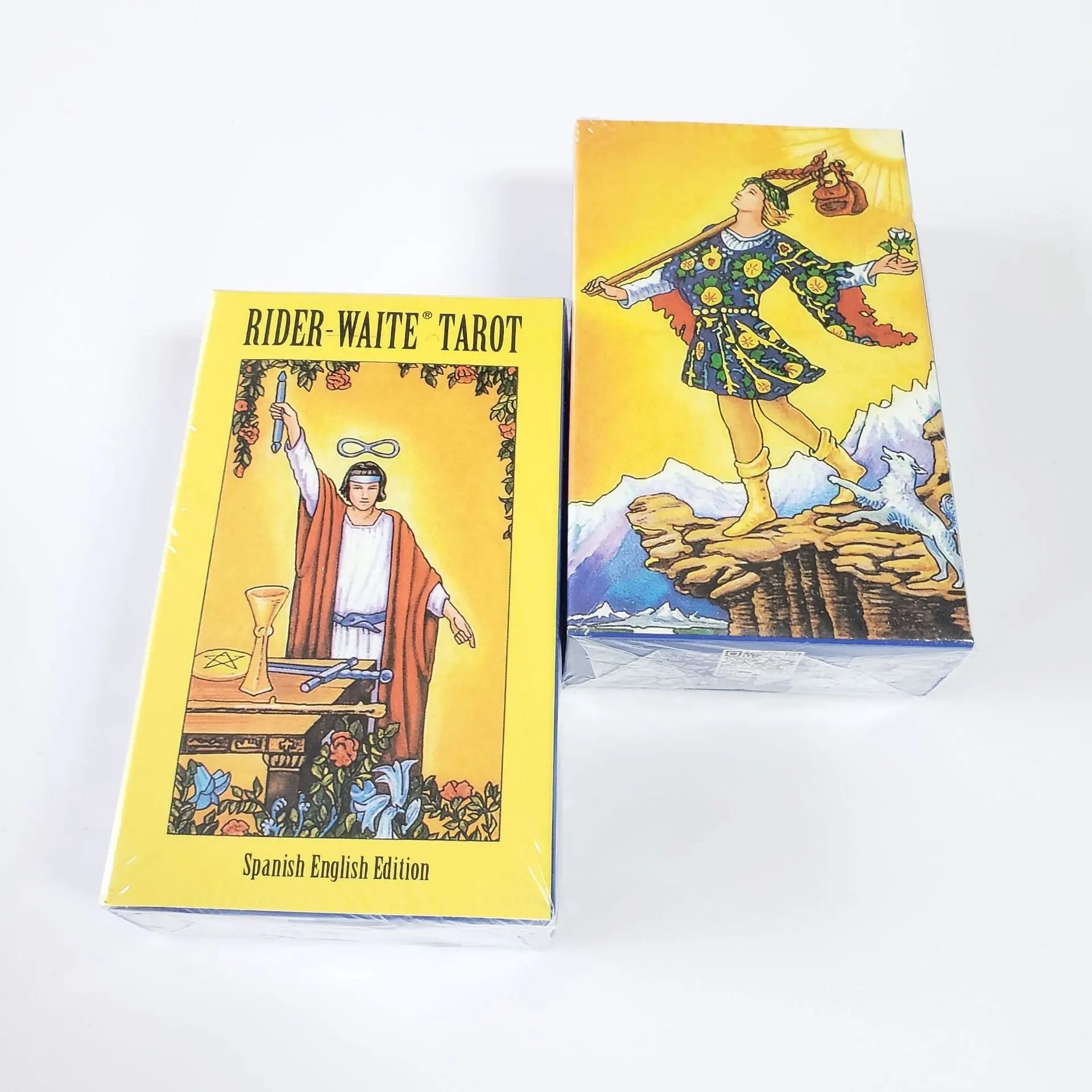 Two yellow Rider-Waite Tarot Spanish English Edition boxes featuring illustrations of The Magician and The Fool.