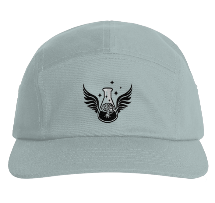 A front view of a light grey-green "mineral" five-panel camper style hat sitting isolated on a white background. Centered on the front panel is a sharp black embroidered insignia depicting a chemistry beaker flask flanked by outspread black wings, with an illustrative human brain root design enclosed within the beaker under small black stars.