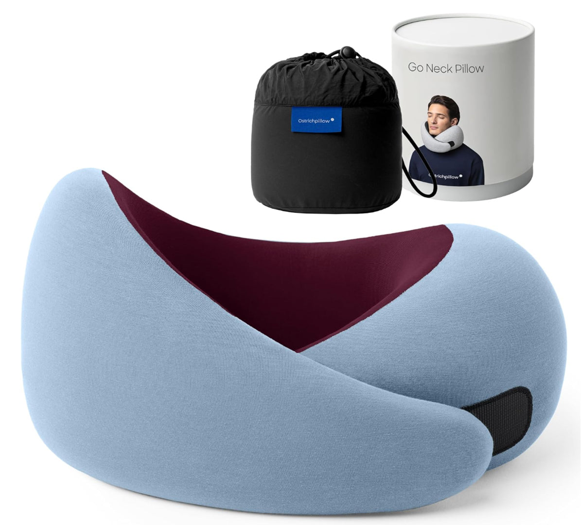 Anakha H. Nyx travel memory foam neck pillow from the Dark Utility Collection in powder blue with a burgundy interior, fine modal-blend knit cover, asymmetrical ergonomic wrap construction, hook-and-loop closure, and black compression storage bag with branded travel canister. Image displays textured stretch fabric, supportive memory foam core, clean utility styling, and travel-ready construction suited to dark streetwear, minimalist gothic apparel, and corporate goth accessories.