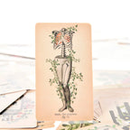 The Empress tarot card showing a human ribcage and pelvis anatomy collage layered with orange lungs and climbing ivy.
