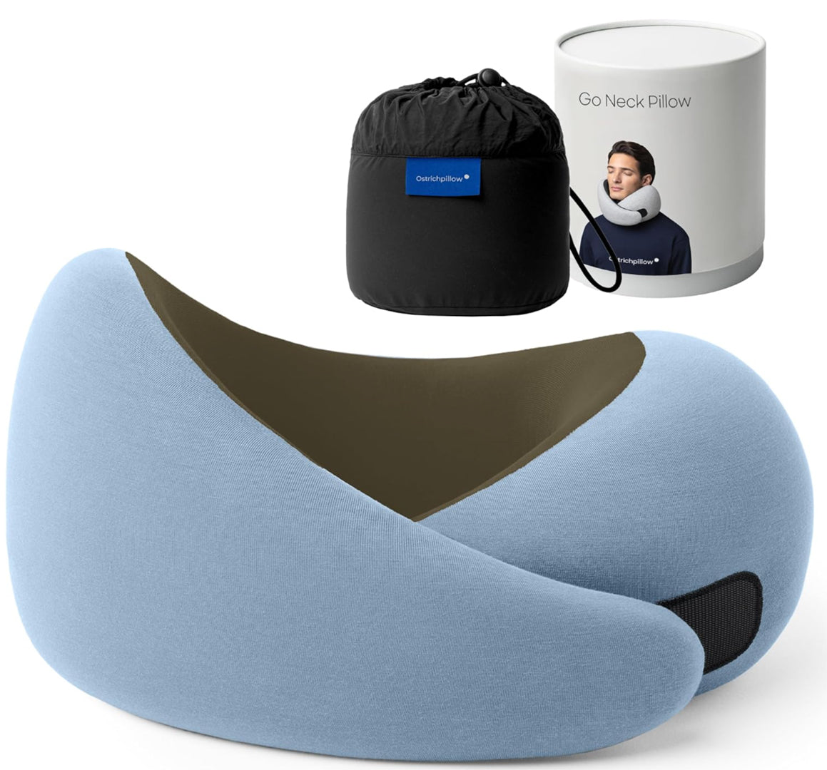 Anakha H. Nyx travel memory foam neck pillow from the Dark Utility Collection in pastel blue with an olive interior lining, soft modal-blend knit fabric, asymmetrical ergonomic wrap design, hook-and-loop closure, and black compression storage bag with branded travel canister. Image highlights supportive memory foam, stretch textile texture, minimalist utility detailing, and functional styling for dark streetwear, alternative fashion, travel accessories, and corporate goth aesthetics.