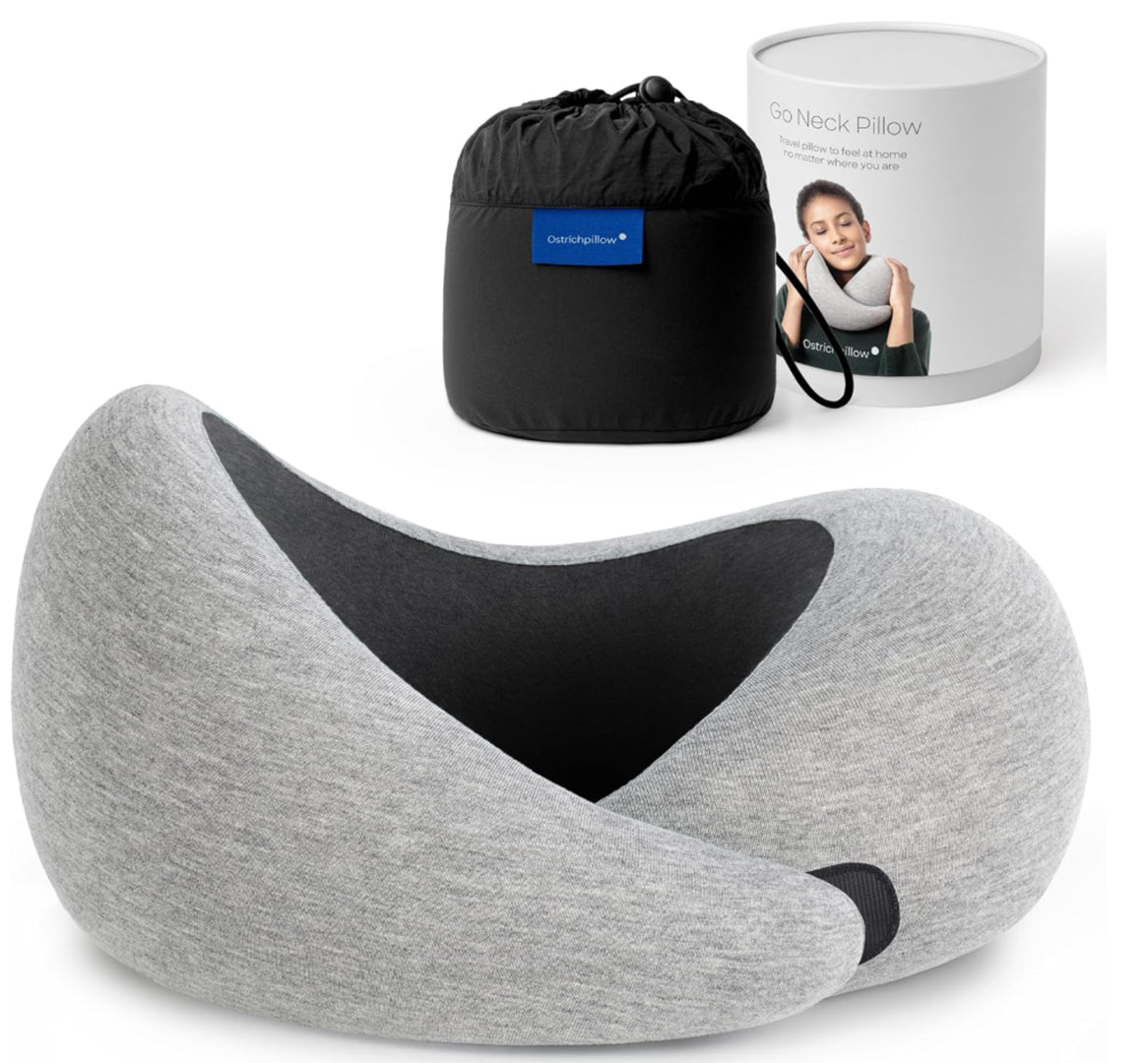 Travel memory foam neck pillow from the Dark Utility Collection in deep indigo with a tonal interior, modal-blend knit cover, asymmetrical ergonomic construction, hook-and-loop fastening, and black compression storage bag with branded travel canister.