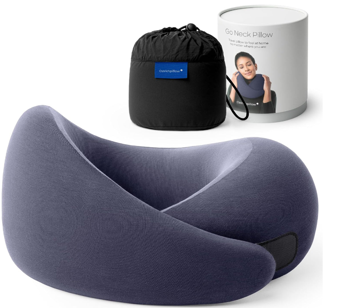 Travel memory foam neck pillow from the Dark Utility Collection in deep indigo with a tonal interior, modal-blend knit cover, asymmetrical ergonomic construction, hook-and-loop fastening, and black compression storage bag with branded travel canister.