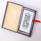 The Pulp Tarot boxed set by the Unemployed Philosophers Guild features a magnetic book-style storage box that opens to reveal an included instruction booklet. The premium packaging integrates a built-in red satin ribbon pull designed for easy card and guidebook removal.