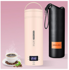 A product layout of the QRAGJBM blush pink portable electric travel kettle showing its digital LED temperature display set to 212 degrees Fahrenheit next to a black leather storage bag. The image features the detachable white power plug accessories on the top left and a steaming cup of fresh coffee at the bottom left.