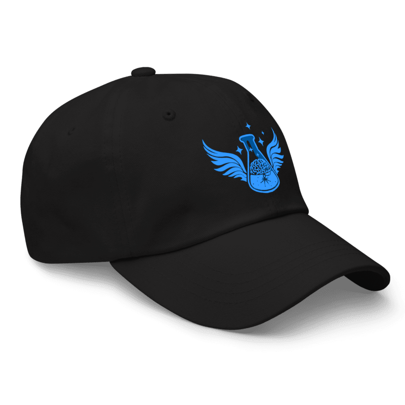 Side view of the black embroidered Creative Catalyst Cap by Anakha H Nyx Store against a transparent grid background.
