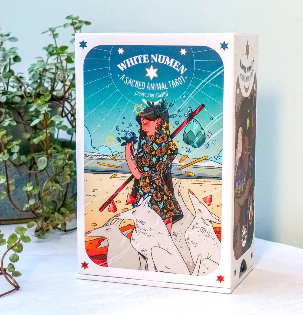 The front of the White Numen Tarot box featuring a hand-drawn fantasy comic illustration of a traveler and white wolves.
